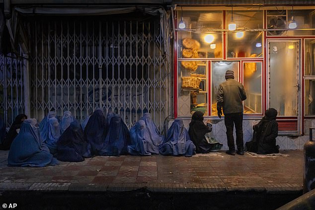 File image of women and children begging for bread outside a bakery in central Kabul, Afghanistan, Jan. 14, 2022