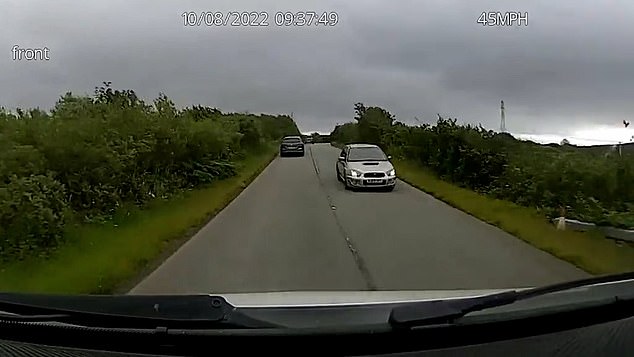 Finlay MacDonald's Subaru Impreza (right) is seen heading for the Scottish mainland on August 10 2022