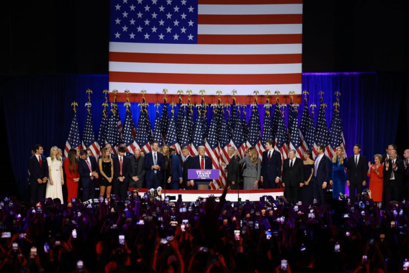 WEST PALM BEACH, FLORIDA - NOVEMBER 06:  Republican presidential nominee, former U.S. President Donald Trump arrives to speak as members of his family look on during an election night event at the Palm Beach Convention Center on November 06, 2024 in West Palm Beach, Florida. Americans cast their ballots today in the presidential race between Republican nominee former President Donald Trump and Vice President Kamala Harris, as well as multiple state elections that will determine the balance of power in Congress.   (Photo by Joe Raedle/Getty Images)