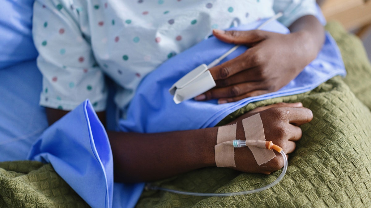 patient lying in the hospital bed with IV