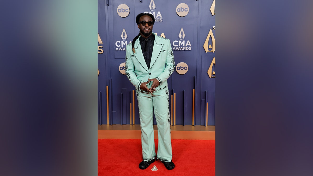 Shaboozey looked dapper in a mint green suit on the red carpet at the 2024 CMA Awards.