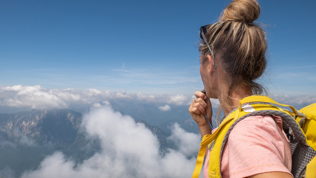 Woman drinking from hydration pack