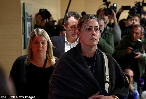 Caroline Darian (R) leaves the courtroom in Avignon on December 19, 2024, after hearing the verdict in the trial of her father, with 50 others, accused of drugging his wife and orchestrating multiple rapes over nearly a decade. A court in the French southern town of Avignon is trying Dominique Pelicot, a 71-year-old retiree, for repeatedly raping and enlisting dozens of strangers to rape his heavily sedated wife Gisele Pelicot in her own bed over a decade. Fifty other men, aged between 26 and 74, are also on trial for alleged involvement, in a case that has horrified France. (Photo by Clement MAHOUDEAU / AFP) (Photo by CLEMENT MAHOUDEAU/AFP via Getty Images)