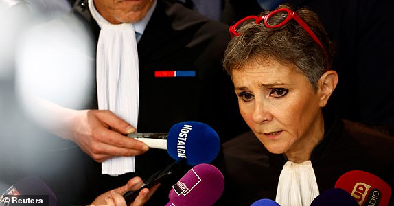 Beatrice Zavarro, the lawyer of Dominique Pelicot, a Frenchman accused of drugging his then-wife Gisele Pelicot and recruiting dozens of strangers to rape her at their home in the southern French town of Mazan, talks to journalists after the verdict in the trial for Dominique Pelicot and 50 co-accused, at the courthouse in Avignon, France, December 19, 2024. REUTERS/Manon Cruz