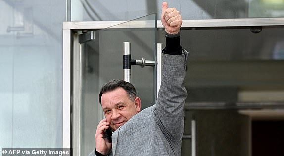 David Pelicot waves to supporters gathered outside the courthouse as he leaves the courtroom in Avignon on December 19, 2024, after hearing the verdict in the trial of his father, with 50 others, accused of drugging his wife and orchestrating multiple rapes over nearly a decade. A court in the French southern town of Avignon is trying Dominique Pelicot, a 71-year-old retiree, for repeatedly raping and enlisting dozens of strangers to rape his heavily sedated wife Gisele Pelicot in her own bed over a decade. Fifty other men, aged between 26 and 74, are also on trial for alleged involvement, in a case that has horrified France. (Photo by Sylvain THOMAS / AFP) (Photo by SYLVAIN THOMAS/AFP via Getty Images)