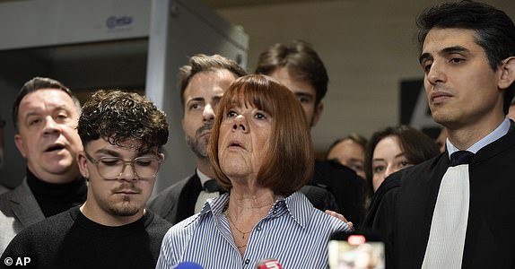 Gisele Pelicot speaks to the press as he leaves the courtroom, in the Avignon courthouse, southern France, Thursday, Dec. 19, 2024. (AP Photo/Lewis Joly)