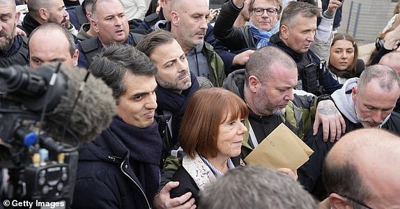 AVIGNON, FRANCE - DECEMBER 19: Gisele Pelicot leaves the courthouse next to her lawyer Stephane Babonneau (L) after a verdict in the Pelicot case on December 19, 2024 in Avignon, France. Gisele Pelicot's ex-husband, Dominique Pelicot, and 50 other men were convicted today on charges of raping her over a multiyear period, in encounters arranged by Mr. Pelicot while she was drugged and unconscious. (Photo by Julien Goldstein/Getty Images)