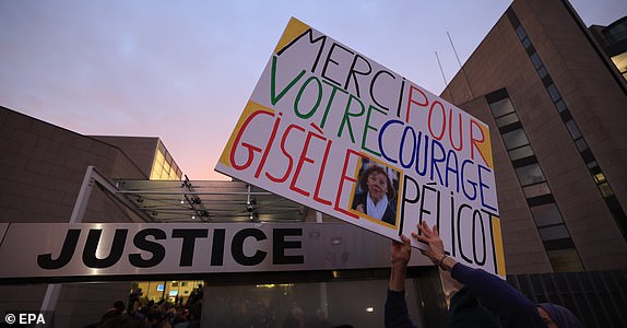 epa11784811 A woman holds a sign reading 'Thank you for your courage Gisele Pelicot' in front the criminal court before the Dominique Pelicot trial, in Avignon, South of France, 19 December 2024. Judges will hand down verdicts on 51 men in the mass rape trial in which Dominique Pelicot is accused of drugging and raping his then-wife, Gisele Pelicot as well as inviting dozens of men to rape her while she was unconscious at their home in Mazan, France, between 2011 and 2020.  EPA/GUILLAUME HORCAJUELO