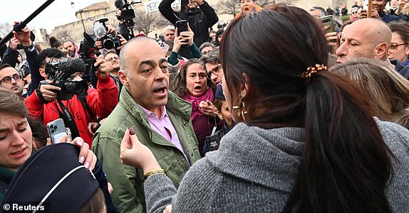 Christophe Bruschi, lawyer of one of co-accused, talks with supporters of Frenchwoman Gisele Pelicot, the victim of an alleged mass rape orchestrated by her then-husband Dominique Pelicot at their home in the southern French town of Mazan, in front of the courthouse after the verdict in the trial for Dominique Pelicot and 50 co-accused, in Avignon, France, December 19, 2024.REUTERS/Alexandre Dimou