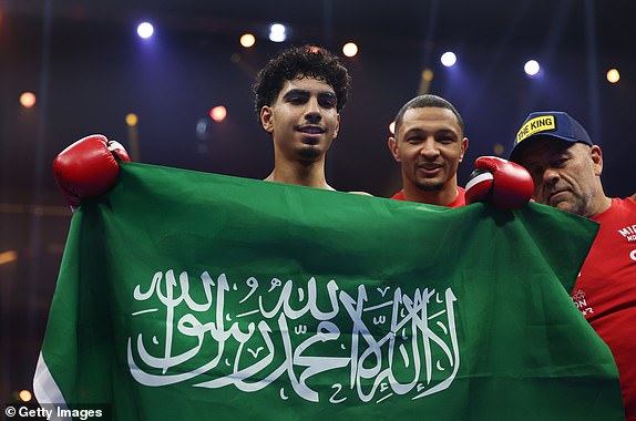 RIYADH, SAUDI ARABIA - DECEMBER 21: Mohammed Alakel celebrates victory with the Saudi Arabia flag after the Lightweight fight between Mohammed Alakel and Joshua Ocampo as part of Oleksandr Usyk v Tyson Fury 2, Reignited card at Kingdom Arena on December 21, 2024 in Riyadh, Saudi Arabia. (Photo by Richard Pelham/Getty Images)