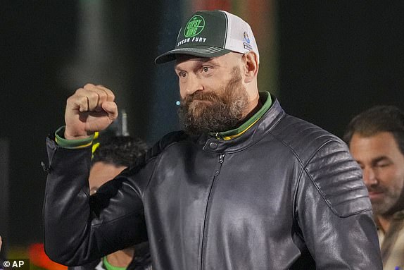 Britain's Tyson Fury arrives for the weigh-in of his WBA, WBO, and WBC heavyweight title boxing bout against World Champion Ukraine's Oleksandr Usyk in Riyadh, Saudi Arabia, Friday, Dec. 20, 2024. (AP Photo/Frank Augstein)