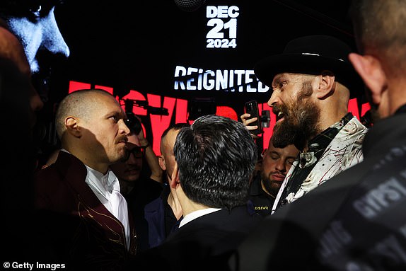 RIYADH, SAUDI ARABIA - DECEMBER 19: Tyson Fury (R) and Oleksandr Usyk face off ahead of the IBF, IBO, WBA, WBC and WBO Undisputed World Heavyweight Title fight between Oleksandr Usyk and Tyson Fury during a press conference as part of Oleksandr Usyk v Tyson Fury 2 at Via Riyadh on December 19, 2024 in Riyadh, Saudi Arabia. (Photo by Richard Pelham/Getty Images)