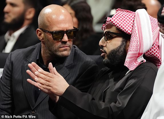 Turki Al-Sheikh speaking with actor Jason Statham (left) at the Kingdom Arena in Riyadh, Saudi Arabia. Picture date: Saturday December 21, 2024. PA Photo. See PA story BOXING Fury. Photo credit should read: Nick Potts/PA Wire.RESTRICTIONS: Use subject to restrictions. Editorial use only, no commercial use without prior consent from rights holder.