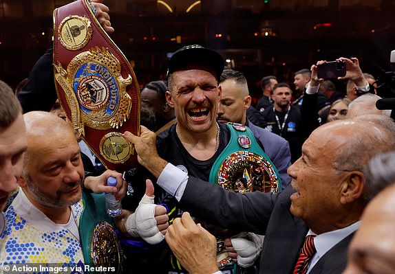 Boxing - Tyson Fury v Oleksandr Usyk - Kingdom Arena, Riyadh, Saudi Arabia - May 19, 2024 Oleksandr Usyk celebrates with the belts after winning the fight to become the undisputed heavyweight world champion Action Images via Reuters/Andrew Couldridge     TPX IMAGES OF THE DAY