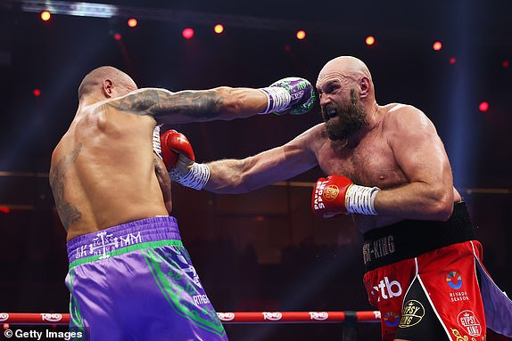 RIYADH, SAUDI ARABIA - DECEMBER 21: Oleksandr Usyk and Tyson Fury exchange punches during the IBF, IBO, WBA, WBC and WBO Undisputed World Heavyweight titles' fight between Oleksandr Usyk and Tyson Fury as part of Oleksandr Usyk v Tyson Fury 2, Reignited card at Kingdom Arena on December 21, 2024 in Riyadh, Saudi Arabia. (Photo by Richard Pelham/Getty Images)