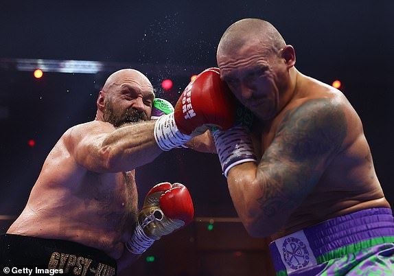 RIYADH, SAUDI ARABIA - DECEMBER 21: Tyson Fury and Oleksandr Usyk exchange punches during the IBF, IBO, WBA, WBC and WBO Undisputed World Heavyweight titles' fight between Oleksandr Usyk and Tyson Fury as part of Oleksandr Usyk v Tyson Fury 2, Reignited card at Kingdom Arena on December 21, 2024 in Riyadh, Saudi Arabia. (Photo by Richard Pelham/Getty Images)