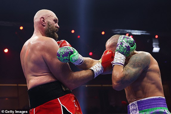 RIYADH, SAUDI ARABIA - DECEMBER 21: Tyson Fury punches Oleksandr Usyk during the IBF, IBO, WBA, WBC and WBO Undisputed World Heavyweight titles' fight between Oleksandr Usyk and Tyson Fury as part of Oleksandr Usyk v Tyson Fury 2, Reignited card at Kingdom Arena on December 21, 2024 in Riyadh, Saudi Arabia. (Photo by Richard Pelham/Getty Images)