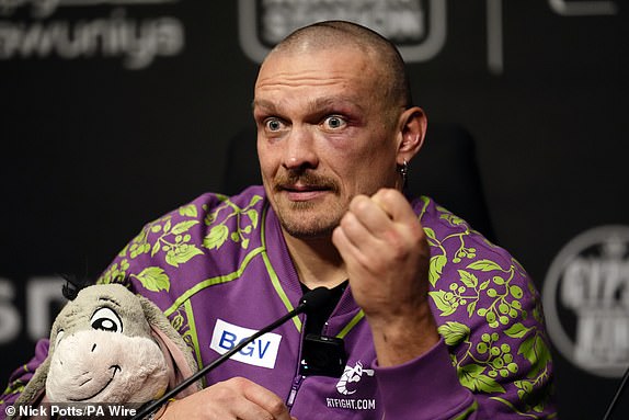 Oleksandr Usyk with an Eeyore teddy during a press conference following his victory over Tyson Fury  at the Kingdom Arena in Riyadh, Saudi Arabia. Picture date: Saturday December 21, 2024. PA Photo. See PA story BOXING Fury. Photo credit should read: Nick Potts/PA Wire.RESTRICTIONS: Use subject to restrictions. Editorial use only, no commercial use without prior consent from rights holder.