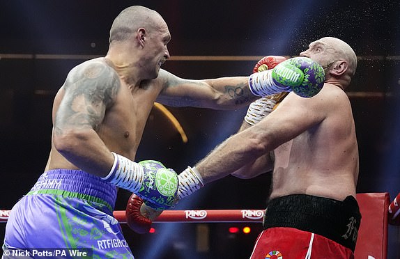 Tyson Fury (right)  and Oleksandr Usyk during the WBA, WBC, WBO, IBO World Heavyweight championship contest at the Kingdom Arena in Riyadh, Saudi Arabia. Picture date: Saturday December 21, 2024. PA Photo. See PA story BOXING Fury. Photo credit should read: Nick Potts/PA Wire.RESTRICTIONS: Use subject to restrictions. Editorial use only, no commercial use without prior consent from rights holder.