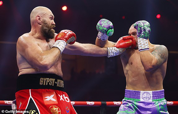 RIYADH, SAUDI ARABIA - DECEMBER 21: Tyson Fury punches Oleksandr Usyk during the IBF, IBO, WBA, WBC and WBO Undisputed World Heavyweight titles' fight between Oleksandr Usyk and Tyson Fury as part of Oleksandr Usyk v Tyson Fury 2, Reignited card at Kingdom Arena on December 21, 2024 in Riyadh, Saudi Arabia. (Photo by Richard Pelham/Getty Images)