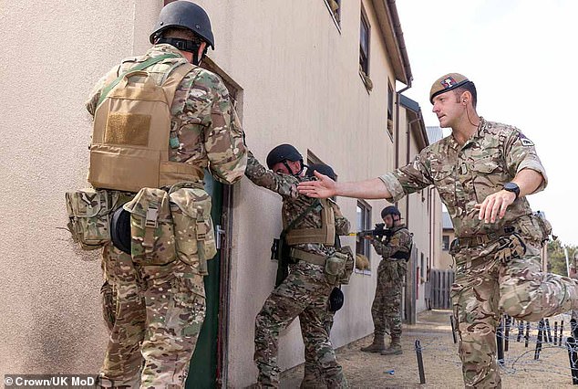 British troops have training more than 51,000 Ukrainian soldiers since 2022. Pictured is a British soldier teaching Ukrainian recruits how to assault a building