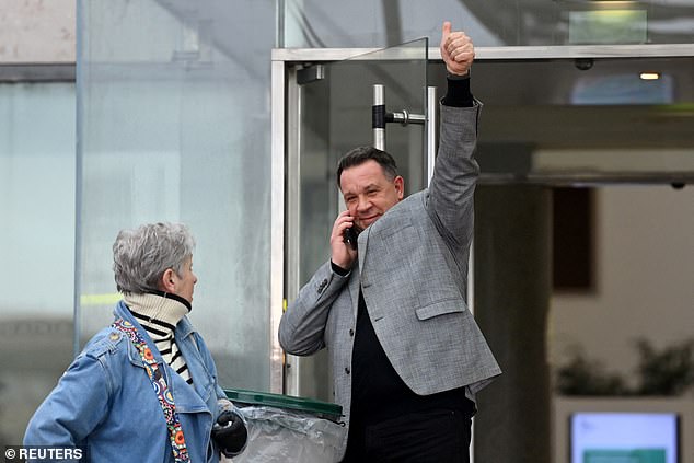 David Pelicot, one of Gisele's two sons, is seen giving a thumbs up as he takes a phone call outside the courthouse after his father was given the maximum sentence of 20 years in jail