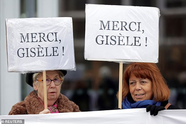 Two women hold placards reading 'thank you Gisele' in support of the French grandmother