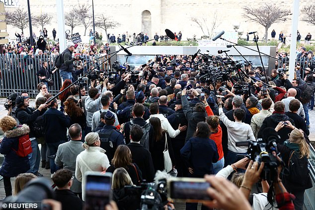 Frenchwoman Gisele Pelicot, the victim of an alleged mass rape orchestrated by her then-husband Dominique Pelicot at their home in the southern French town of Mazan, leaves the courthouse surrounded by French police and journalists after the verdict in the trial for Dominique Pelicot and 50 co-accused, in Avignon, France, December 19, 2024