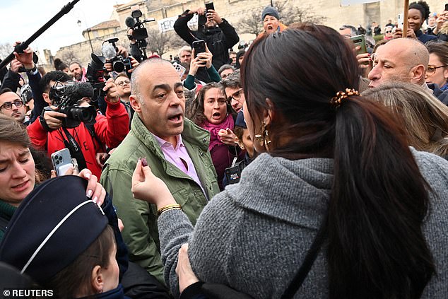 Christophe Bruschi, lawyer of one of co-accused, has a heated discussion with one of the women outside the trial