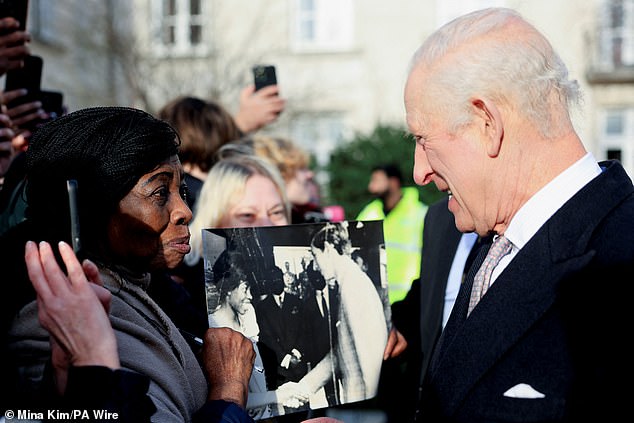 The black and white image shows a young Caroline shaking hands with Charles, 76, who would have been around 21 years old at the time