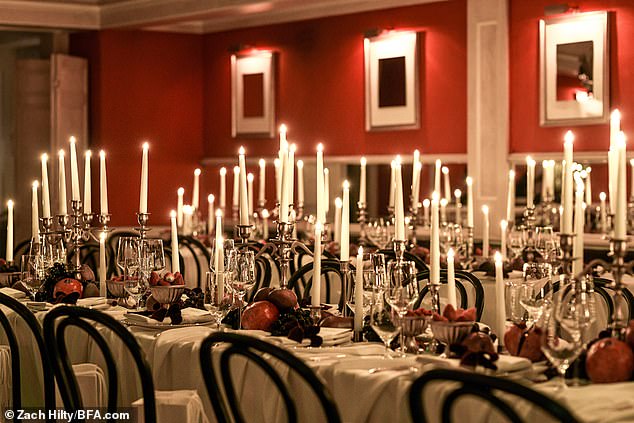 Table settings included a sea of white candles and holiday fruits, decorated to perfection and arranged like a vision