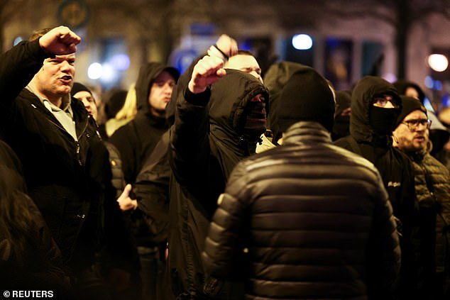 People take part in a protest after a car drove into a crowd at a Christmas market, in Magdeburg