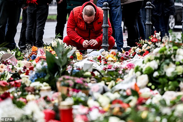 A man mourns at the memorial site for the victims of the Christmas market attack on Friday