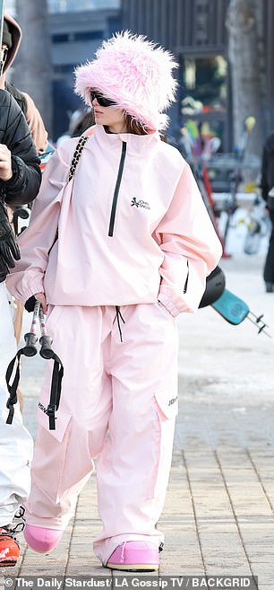 She paired a pink faux-fur hat with a matching $280 John Snow 'Mountain Dope Freestyle' two-piece snowsuit