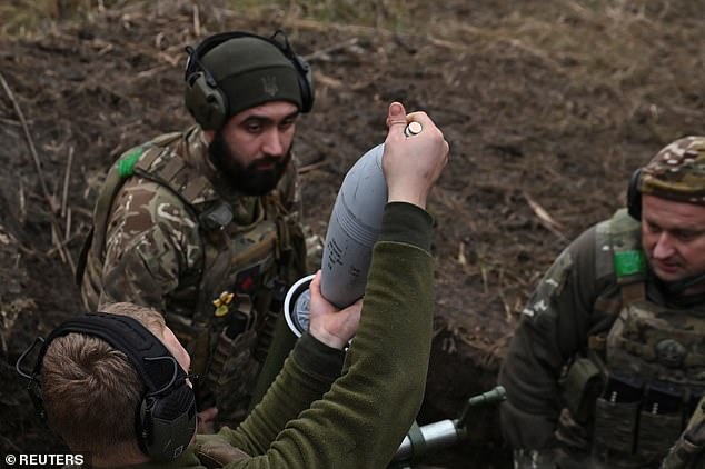 Members of the consolidated Brigade 'Khyzhak' (Predator) of the Ukrainian Patrol Police Department place a shell into a mortar as they fire towards Russian troops at their position in a front line near the town of Toretsk, amid Russia's attack on Ukraine, in Donetsk region, Ukraine December 20, 2024