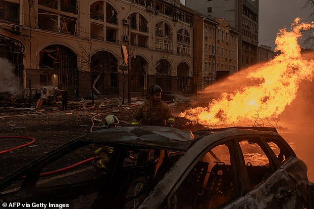 Ukrainian rescuers work to extinguish a fire at the site of a missile attack in Kyiv on December 20, 2024