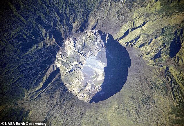 This coming tectonic event, said climate professor Dr Markus Stoffel, will 'cause climate chaos' reminiscent of the 1815 eruption of Indonesia's Mount Tambora. Above, an astronaut image (above) depicts the 6-kilometer-wide summit 'caldera' of the Mount Tambora volcano