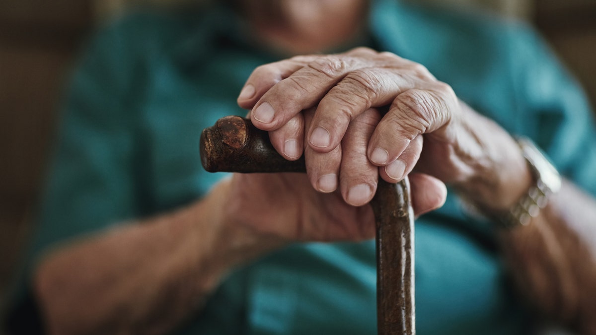 older person with cane