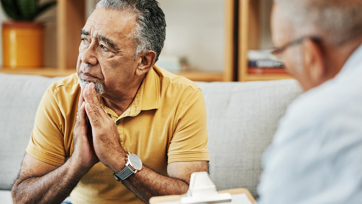 Elderly man talking to a psychologist