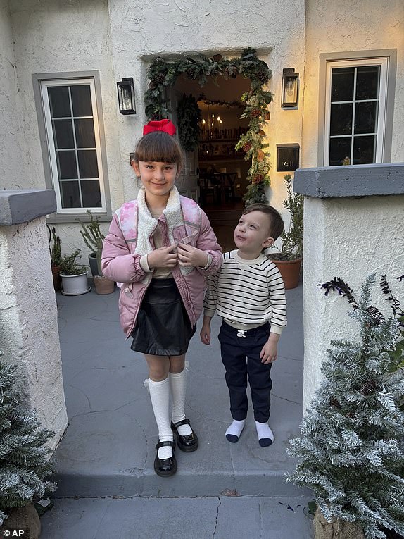 This photo provided by Anna Yaeger shows her daughter and son on the front porch of their Altadena, Calif., home on Dec. 18, 2024, something she did nearly daily until her home burned in the January 2025 wildfires. (Anna Yeager via AP)