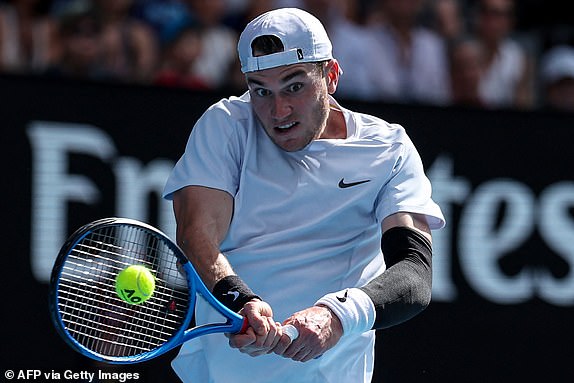 Britain's Jack Draper hits a shot against Spain's Carlos Alcaraz during their men's singles match on day eight of the Australian Open tennis tournament in Melbourne on January 19, 2025. (Photo by Adrian Dennis / AFP) / -- IMAGE RESTRICTED TO EDITORIAL USE - STRICTLY NO COMMERCIAL USE -- (Photo by ADRIAN DENNIS/AFP via Getty Images)