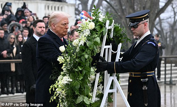 US President-elect Donald Trump lays a wreath at the Tomb of the Unknown Soldier at Arlington National Cemetery in Arlington, Virginia, on January 19, 2025 as Vice President-elect J.D. Vance looks on. (Photo by Jim WATSON / AFP) (Photo by JIM WATSON/AFP via Getty Images)