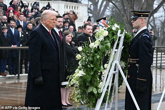 US President-elect Donald Trump lays a wreath at the Tomb of the Unknown Soldier at Arlington National Cemetery in Arlington, Virginia, on January 19, 2025 as Vice President-elect J.D. Vance looks on. (Photo by Jim WATSON / AFP) (Photo by JIM WATSON/AFP via Getty Images)