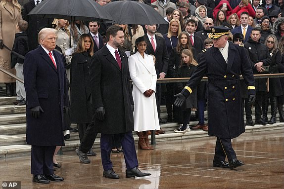 President-elect Donald Trump and Vice President-elect JD Vance are escorted by Maj. Gen. Trevor Bredenkamp, commanding general of the Joint Task Force-National Capital Region and the U.S. Army Military District of Washington,, as Melania Trump and Usha Vance watch as they arrive for a wreath laying ceremony at Arlington National Cemetery, Sunday, Jan. 19, 2025, in Arlington, Va. (AP Photo/Evan Vucci)