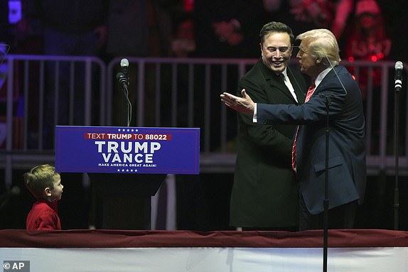 Elon Musk, with his son X Ã¿ A-Xii, arrives on the dais with President-elect Donald Trump, at a rally ahead of the 60th Presidential Inauguration, Sunday, Jan. 19, 2025, in Washington. (AP Photo/Matt Rourke)