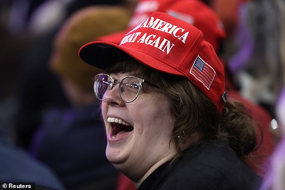 An attendee wears a Make America Great Again hat ahead of an indoor rally on the day of the presidential inauguration of Donald Trump, in Washington, U.S. January 20, 2025. REUTERS/Mike Segar