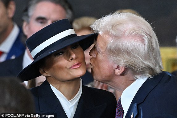 US President-elect Donald Trump kisses Melania Trump as he arrives for the inauguration ceremony before he is sworn in as the 47th US President in the US Capitol Rotunda in Washington, DC, on January 20, 2025. (Photo by SAUL LOEB / POOL / AFP) (Photo by SAUL LOEB/POOL/AFP via Getty Images)