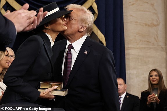 US President-elect Donald Trump greets his wife Melania Trump as he arrives for inauguration ceremonies in the Rotunda of the US Capitol on January 20, 2025 in Washington, DC. Donald Trump takes office for his second term as the 47th president of the United States. (Photo by Chip Somodevilla / POOL / AFP) (Photo by CHIP SOMODEVILLA/POOL/AFP via Getty Images)