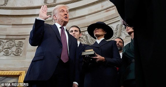 Donald Trump is sworn in as the 47th president of the United States by Chief Justice John Roberts as Melania Trump holds the Bible during the 60th Presidential Inauguration in the Rotunda of the U.S. Capitol in Washington, Monday, Jan. 20, 2025.     Morry Gash/Pool via REUTERS