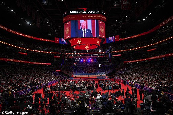 WASHINGTON, DC - JANUARY 20: People watch the inauguration of U.S. President-elect Donald Trump from the Capital One Arena  on January 20, 2025 in Washington, DC. Donald Trump takes office for his second term as the 47th president of the United States. (Photo by Christopher Furlong/Getty Images)